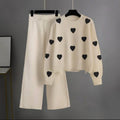 cream tracksuit with (black hearts)